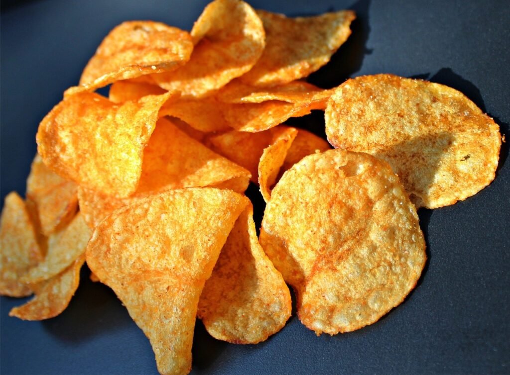 Bags of chips on a table ready for serving at a party, perfect for a gathering of 20 people.